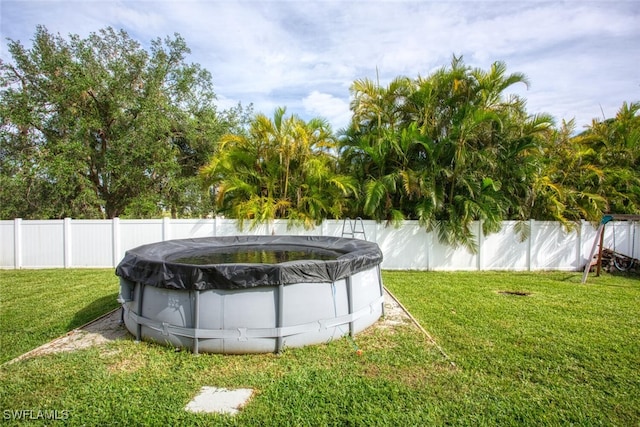 view of yard with a covered pool