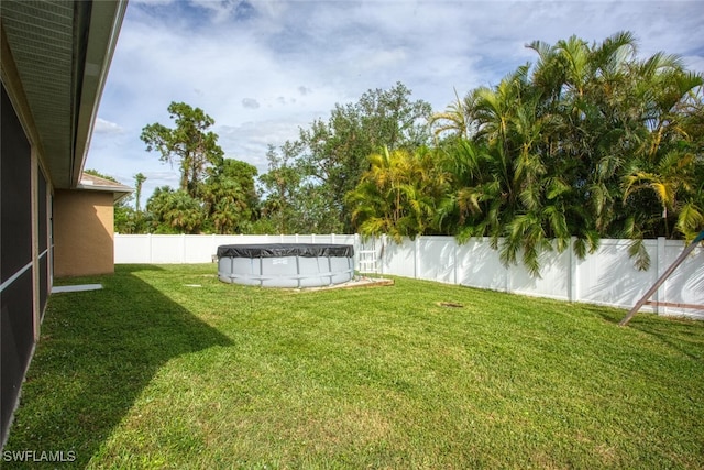 view of yard featuring a covered pool