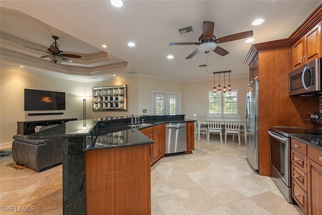 kitchen with ceiling fan with notable chandelier, stainless steel appliances, crown molding, sink, and decorative light fixtures