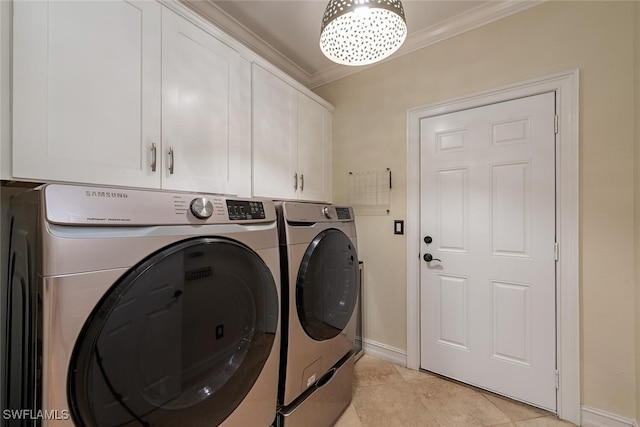 laundry room featuring washer and dryer, light tile patterned flooring, cabinets, and crown molding