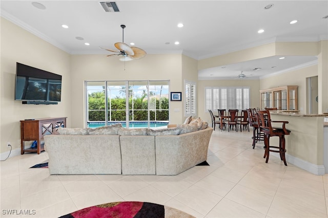 tiled living room featuring ceiling fan and ornamental molding