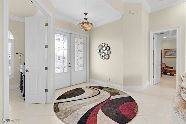 tiled entrance foyer featuring ornamental molding and french doors