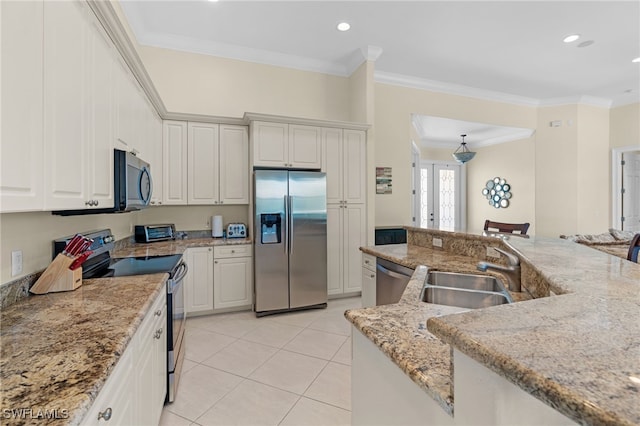 kitchen featuring light stone countertops, appliances with stainless steel finishes, white cabinetry, and sink