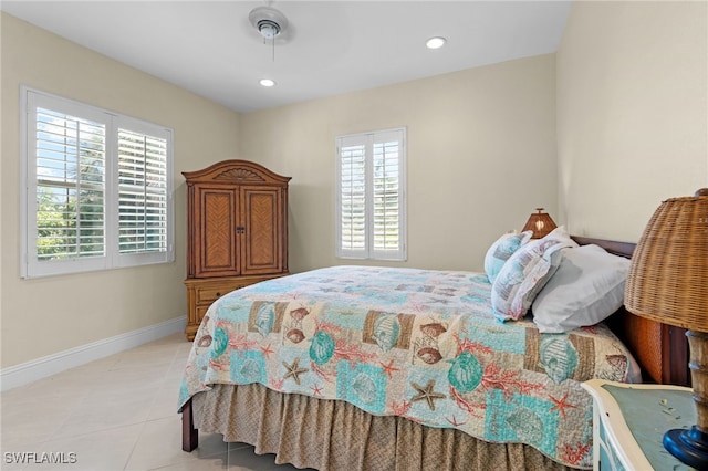 tiled bedroom featuring ceiling fan