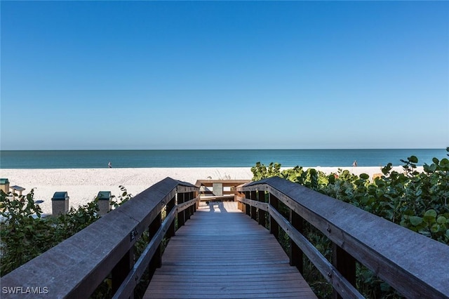 exterior space featuring a beach view and a water view