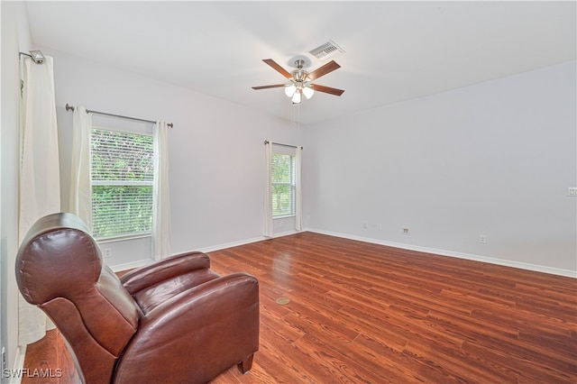 living area featuring ceiling fan and wood-type flooring