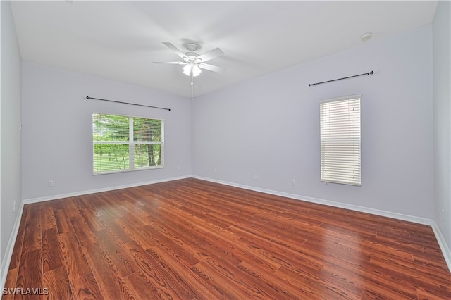 spare room featuring dark hardwood / wood-style floors and ceiling fan