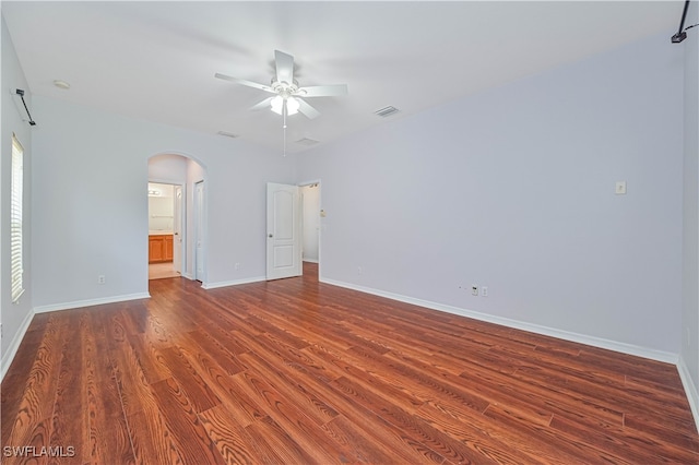 unfurnished room with ceiling fan and dark hardwood / wood-style flooring