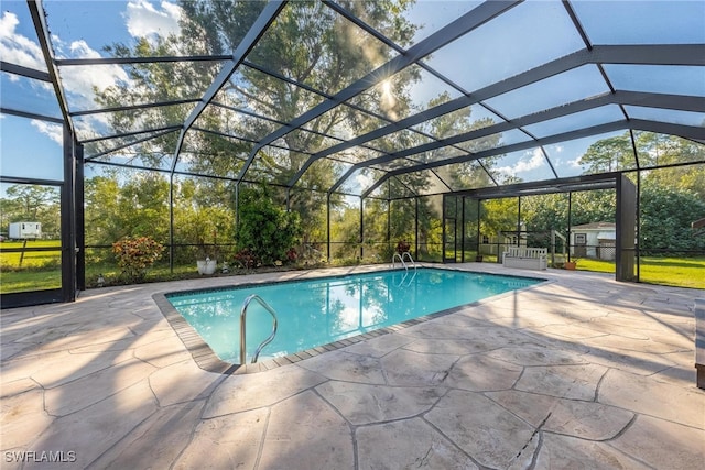 view of pool with a lanai and a patio area