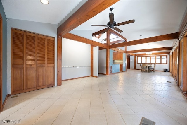 unfurnished living room with vaulted ceiling with beams, ceiling fan, and light tile patterned flooring