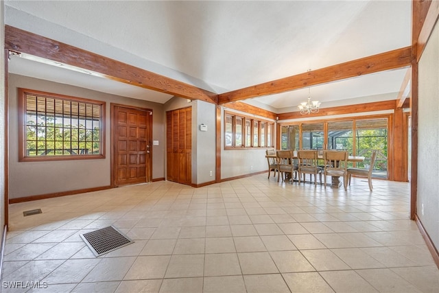 unfurnished dining area with a notable chandelier, beam ceiling, and a wealth of natural light