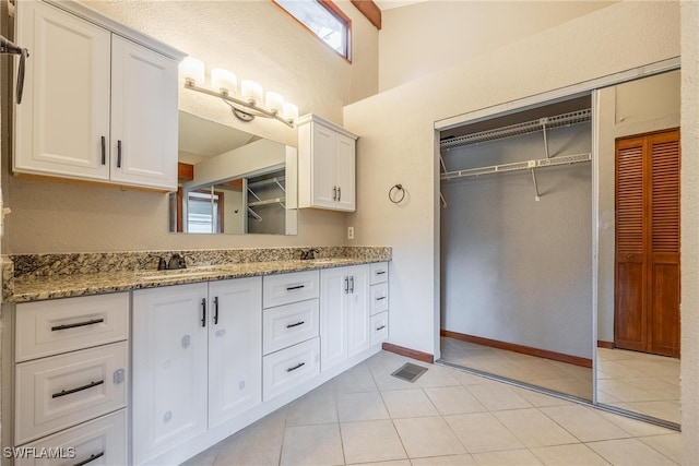 bathroom featuring tile patterned flooring and vanity