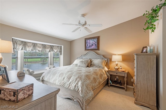 carpeted bedroom with vaulted ceiling and ceiling fan