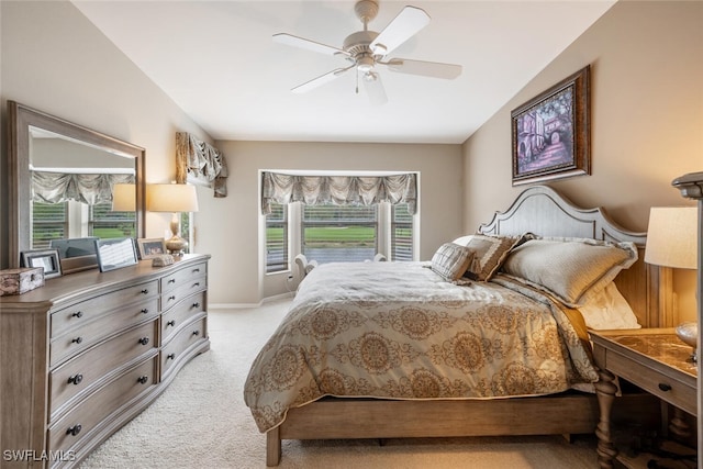 bedroom featuring ceiling fan, light colored carpet, and vaulted ceiling