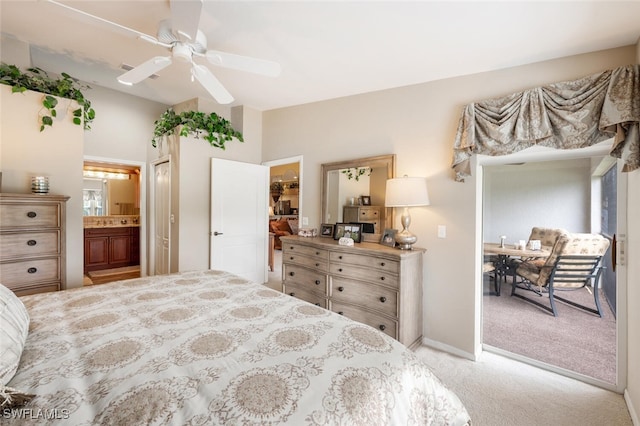 bedroom with light carpet, a closet, ensuite bathroom, and ceiling fan