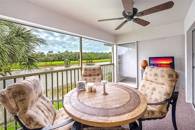 sunroom / solarium featuring ceiling fan