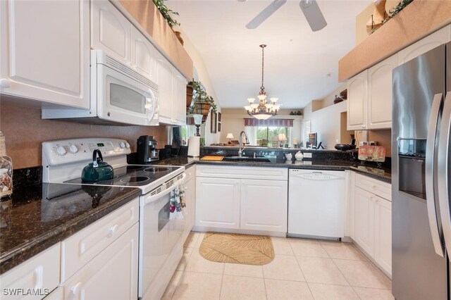 kitchen with white cabinetry, sink, light tile patterned flooring, and white appliances