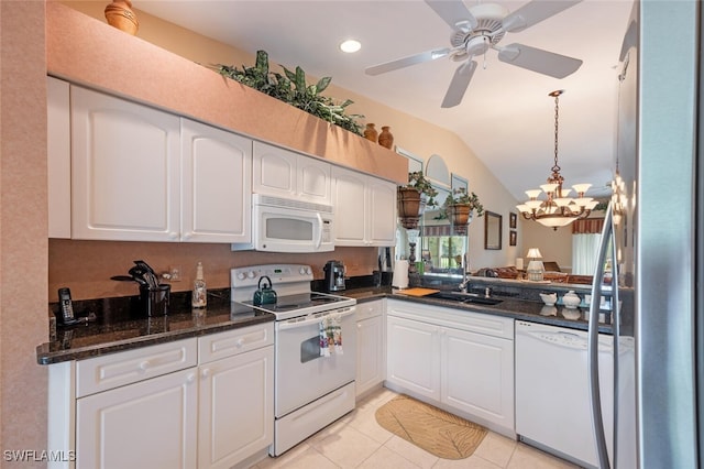 kitchen featuring vaulted ceiling, white cabinets, and white appliances