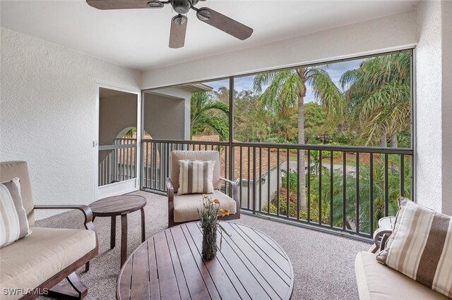 sunroom featuring ceiling fan