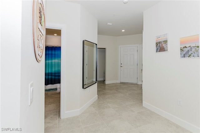 corridor with light tile patterned floors