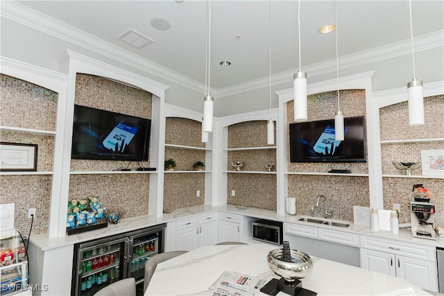 living room featuring ornamental molding, sink, and beverage cooler