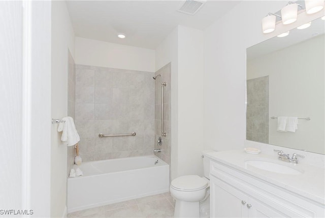 full bathroom with vanity, tiled shower / bath combo, tile patterned floors, and toilet