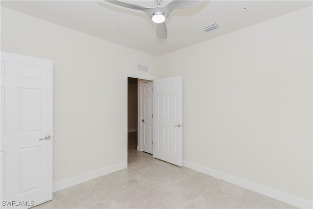 unfurnished room featuring light tile patterned floors and ceiling fan