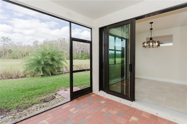 unfurnished sunroom with a notable chandelier