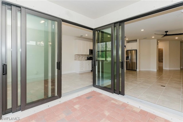 property entrance with ceiling fan