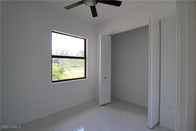 unfurnished bedroom featuring a closet and ceiling fan