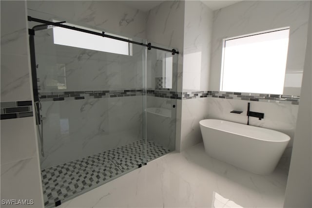 bathroom featuring tile walls and shower with separate bathtub