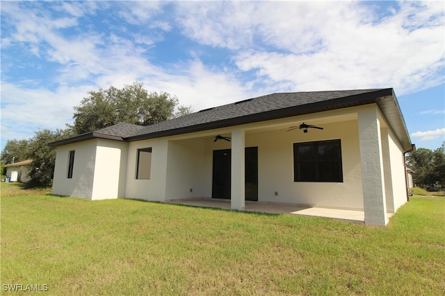 back of house featuring ceiling fan, a patio area, and a yard