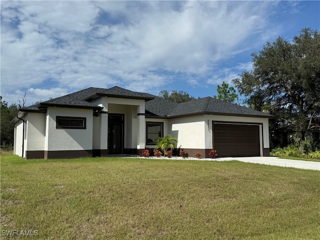 prairie-style home with a garage and a front lawn