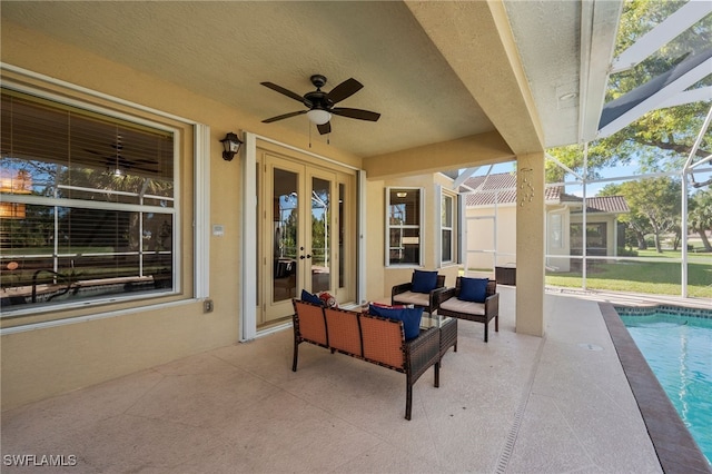 view of patio with glass enclosure, ceiling fan, french doors, and outdoor lounge area