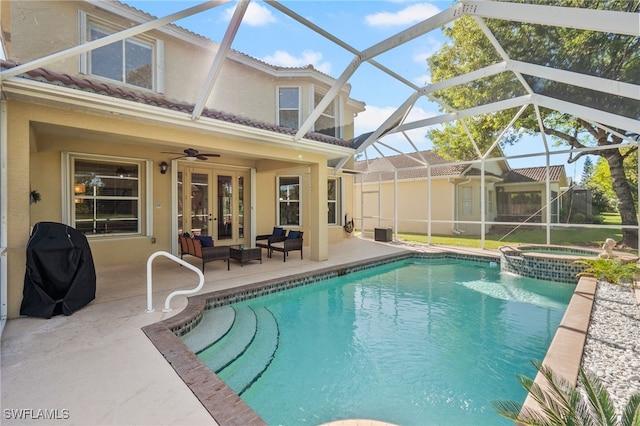 view of swimming pool featuring an in ground hot tub, french doors, a lanai, a patio area, and a grill