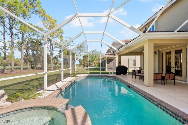 view of swimming pool with a patio area, a lanai, an in ground hot tub, and french doors