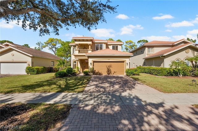 mediterranean / spanish-style home featuring a balcony, a front yard, and a garage