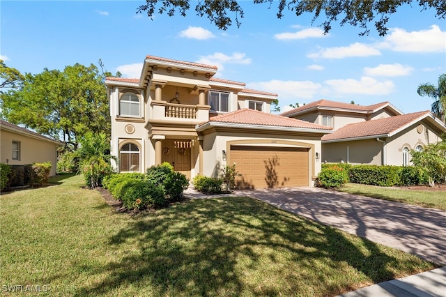 mediterranean / spanish house featuring a balcony and a front lawn