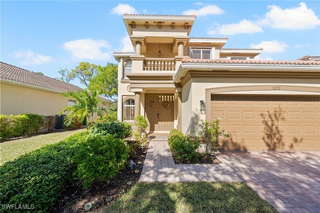 mediterranean / spanish-style home with a balcony and a garage