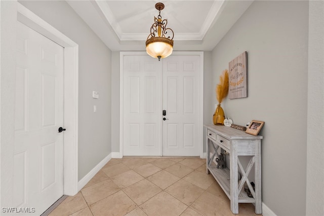 tiled foyer with a tray ceiling