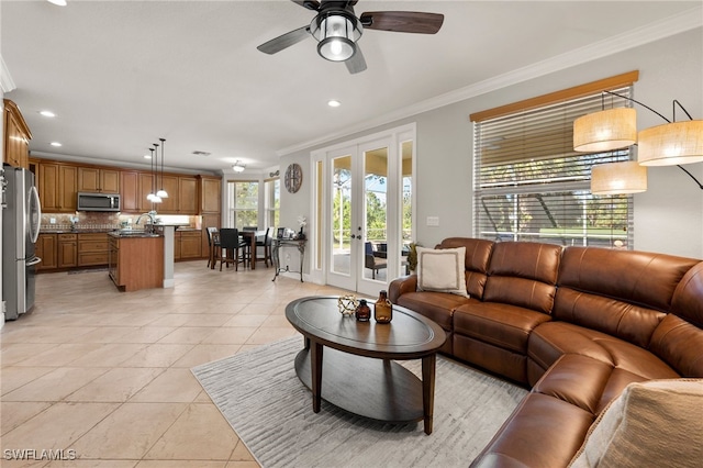 living room with ceiling fan, ornamental molding, light tile patterned floors, and french doors