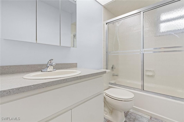 full bath with combined bath / shower with glass door, vanity, and toilet