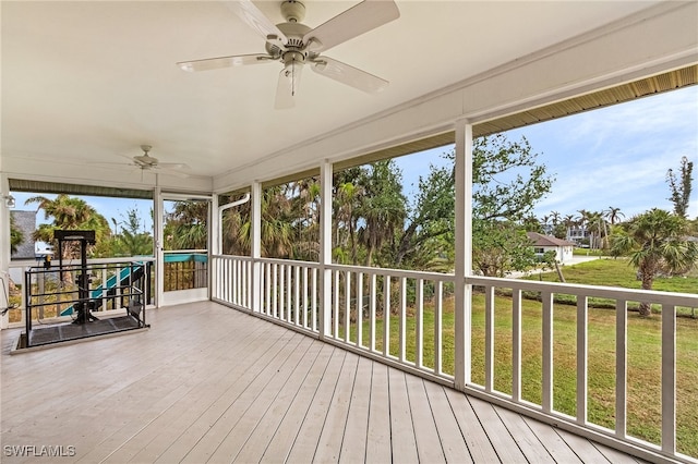 unfurnished sunroom with plenty of natural light and ceiling fan