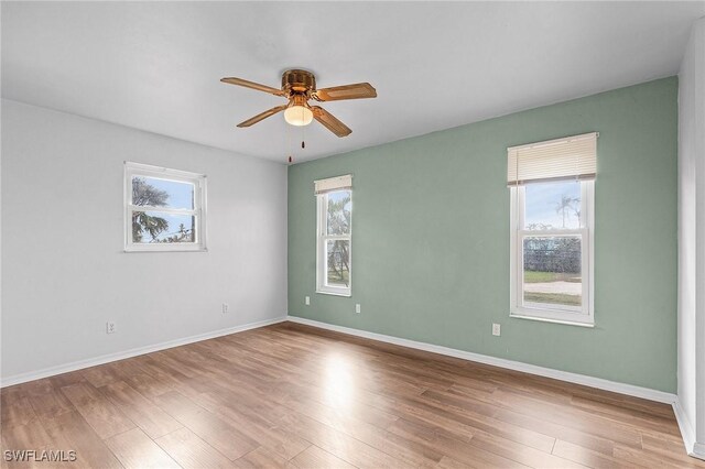 unfurnished room featuring hardwood / wood-style floors and ceiling fan