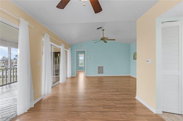 unfurnished living room with lofted ceiling and light wood-type flooring