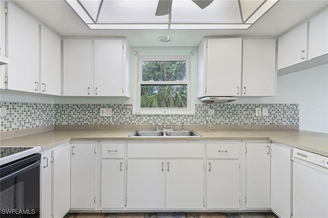 kitchen with tasteful backsplash, light countertops, white dishwasher, and a sink