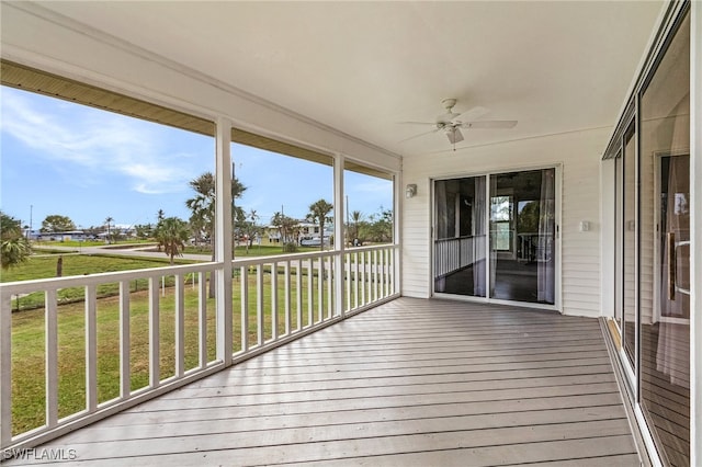 unfurnished sunroom with a wealth of natural light and ceiling fan