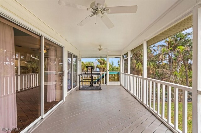 unfurnished sunroom with ceiling fan and a healthy amount of sunlight