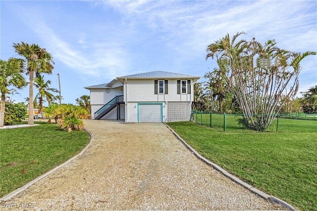 view of front of home featuring a front yard and a garage