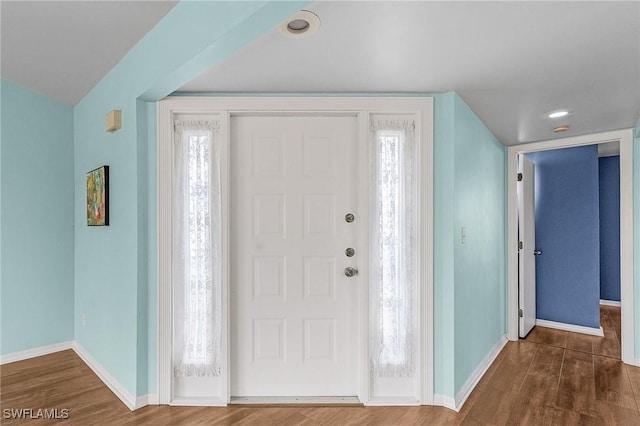 foyer entrance with recessed lighting, baseboards, and wood finished floors